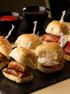 Bacon and sausage breakfast sliders on a slate, as part of mercure hotels meeting food offering